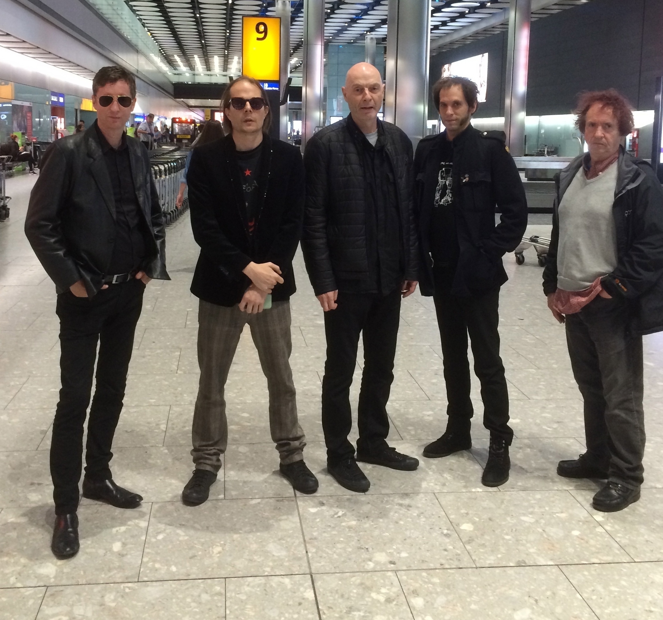 The classic "tired band at an airport" photograph.